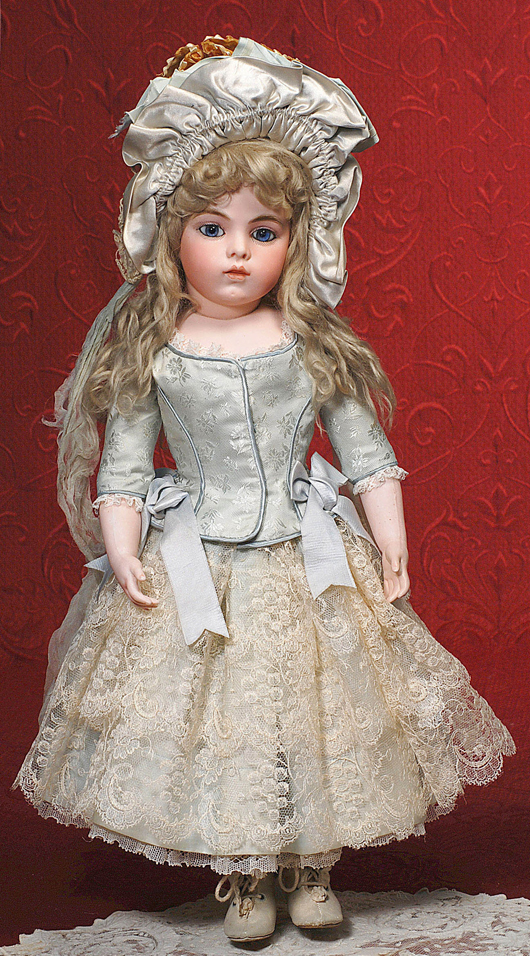 Jumeau Bebe known as 'Portrait' - early model with original boutique label in antique costume. Image courtesy Frasher's Doll Auctions.